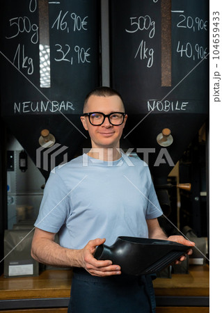 Coffee shop worker standing at counter. 104659433
