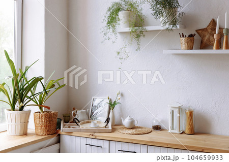 White kitchen interior with wooden countertop White kitchen interior with wooden countertop 104659933