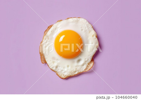 Delicious scrambled eggs in purple background isolated top view Delicious scrambled eggs in purple background isolated top view 104660040