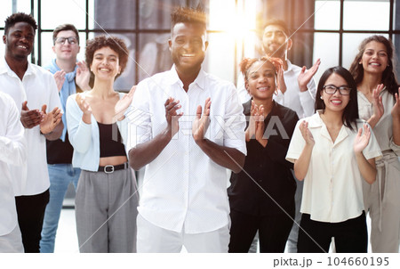 High angle view of multiethnic people cheering after a seminar High angle view of multiethnic people cheering after a seminar 104660195