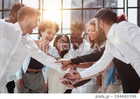 High Angle View Of Multiracial Friend Stacking Hand Together 104660396