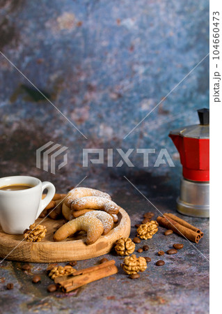 Oriental Algerian sweet cookies, coffee cup and cinnamon stick. Light background Oriental Algerian sweet cookies, coffee cup and cinnamon stick. Light background 104660473