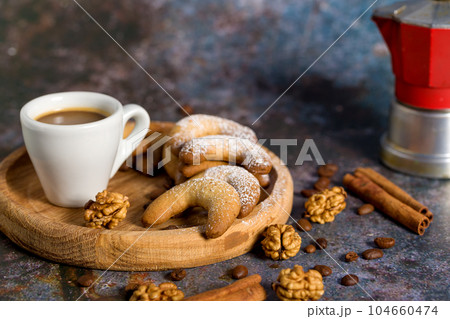 Oriental Algerian sweet cookies, coffee cup and cinnamon stick. Light background Oriental Algerian sweet cookies, coffee cup and cinnamon stick. Light background 104660474