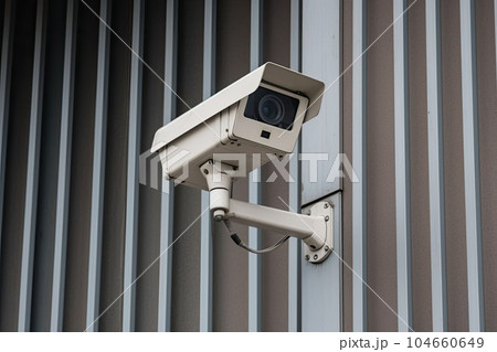 Security camera on modern building. CCTV on the wall in the city. Generative AI Security camera on modern building. CCTV on the wall in the city. Generative AI 104660649