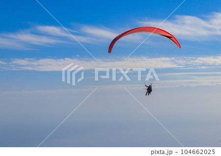 Paragliders in blue sky. Concept of active lifestyle and extreme sport adventure Paragliders in blue sky. Concept of active lifestyle and extreme sport adventure 104662025