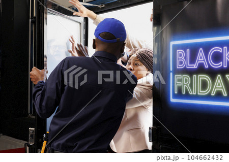 Eager shoppers waiting for fashion boutique door to be thrown open on Black Friday. Crazy obsessed with seasonal sales people rushing to enter store, trying to get into shopping mall. Eager shoppers waiting for fashion boutique door to be thrown open on Black Friday. Crazy obsessed with seasonal sales people rushing to enter store, trying to get into shopping mall. 104662432
