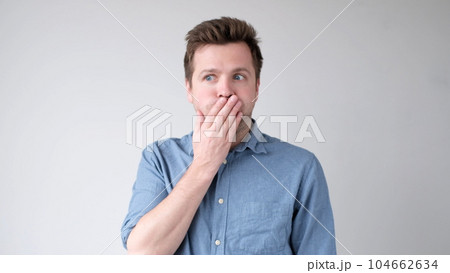 The young man is trying to keep a secret. he doesn't want to speak. The young man is trying to keep a secret. he doesn't want to speak. 104662634