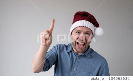 Funny Man in a New Year's Hat Counts Fingers, like Shows Numbers Funny Man in a New Year's Hat Counts Fingers, like Shows Numbers 104662636