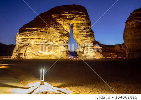Illuminated by lamps sandstone elephant rock erosion monolith standing in the night desert, Al Ula, Saudi Arabia 104662825