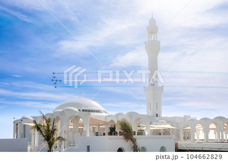 Fighter Jets Squadron with smoke traces over Alrahmah mosque, Jeddah, Saudi Arabia Fighter Jets Squadron with smoke traces over Alrahmah mosque, Jeddah, Saudi Arabia 104662829