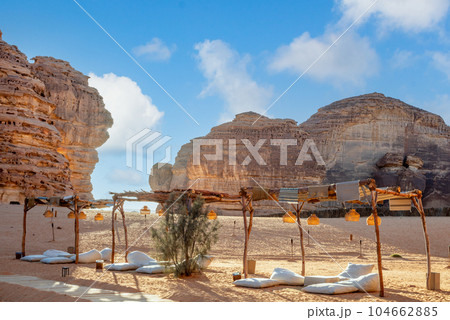 Outdoor lounge in front of elephant rock erosion monolith standing in the desert, Al Ula, Saudi Arabia 104662885