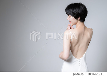 背中が美しい女性のドレス姿　振り返る美人 104665210