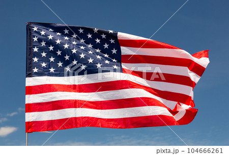 Large USA flag waving against sky Large USA flag waving against sky 104666261