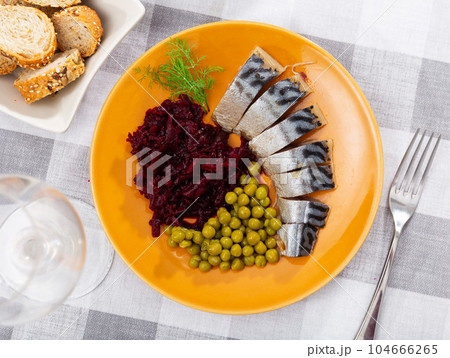 Lightly salted herring fillet with beetroot and green peas closeup Lightly salted herring fillet with beetroot and green peas closeup 104666265