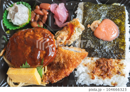 Japanese bento set lunch box of hamburger steak, seaweed on rice, fried fish and Japanese rolled omelet 104666323