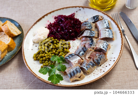 Appetizing cold smoked mackerel with peas and beets 104666333