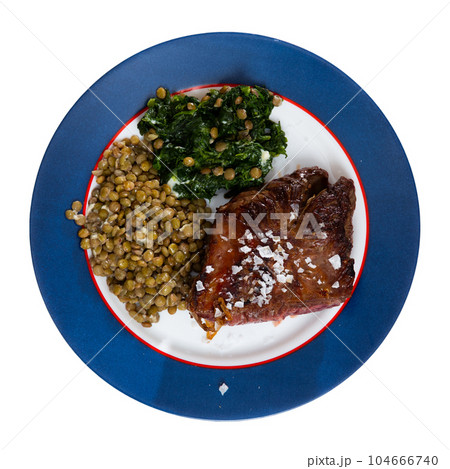 Baked beef loin with green lentils and spinach 104666740