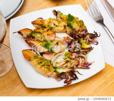 Fried calamari with pesto sauce served in a plate 104666813