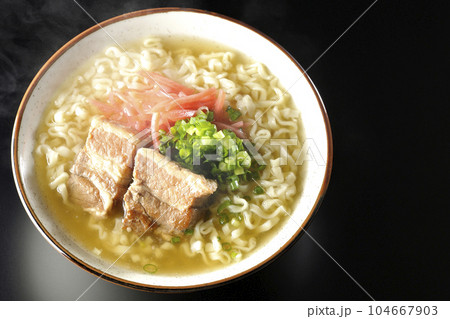 豚のバラ肉とたっぷりの小ねぎと紅生姜入りの熱々沖縄そばを黒背景で俯瞰撮影 104667903