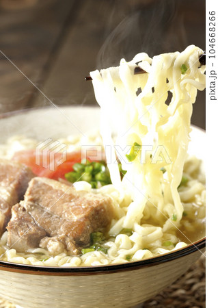 豚のバラ肉とたっぷりの小ねぎと紅生姜入りの熱々沖縄そばを食べる 104668266