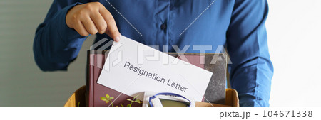 Quit Job Business man sending resignation letter and packing Stuff Resign Depress or carrying business cardboard box in office. Change of job or fired from company. 104671338