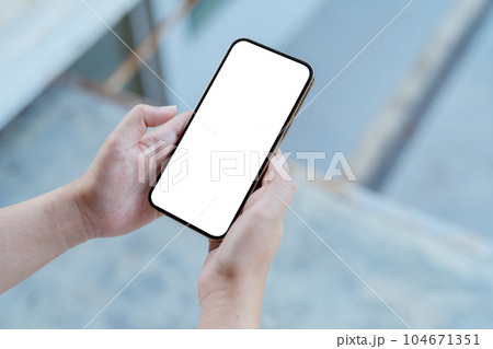 Women's hands holding cell telephone blank copy space screen. smartphone with blank white screen isolated. smart phone with technology concept. Women's hands holding cell telephone blank copy space screen. smartphone with blank white screen isolated. smart phone with technology concept. 104671351