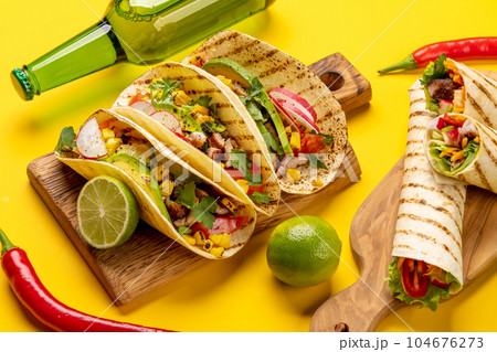Mexican food featuring tacos, burritos, nachos, burgers Mexican food featuring tacos, burritos, nachos, burgers 104676273