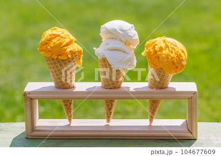 Refreshing ice cream in waffle cones with lemon flavour Refreshing ice cream in waffle cones with lemon flavour 104677609