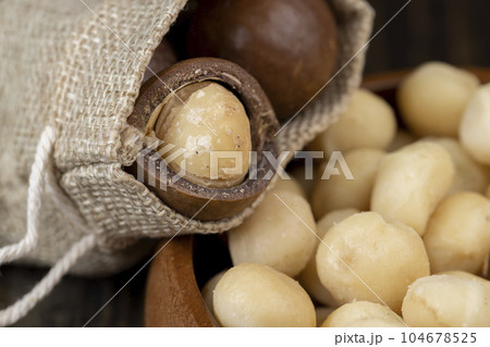 Peeled macadamia nuts on the table Peeled macadamia nuts on the table 104678525