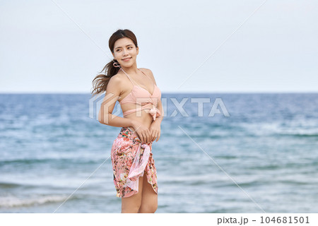 happy young woman in swimsuit at sea 104681501