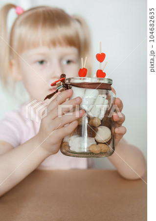 A little girl blogger makes a sweet Valentine's Day gift with her own hands. A gift for the holiday, a video blog entry. A little girl blogger makes a sweet Valentine's Day gift with her own hands. A gift for the holiday, a video blog entry. 104682635