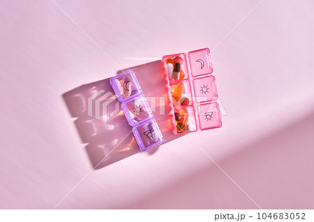 Bright pill box with different pills and vitamins. 104683052