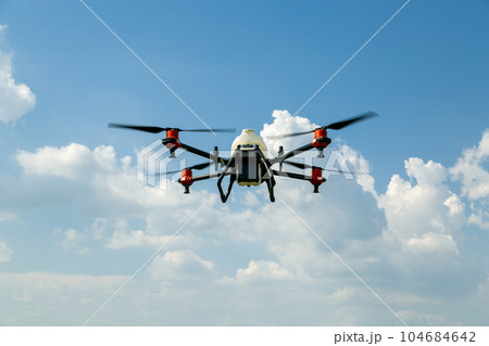 Agriculture drone fly to sprayed fertilizer on the fields. Industrial agriculture and smart farming 104684642