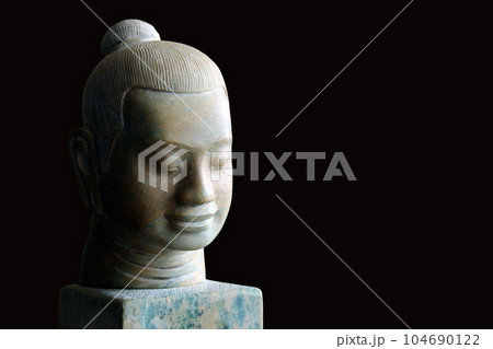 Stone faces of Jayavarman VII, isolated on black background.  104690122