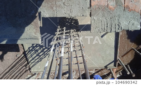 Aerial view of columnar structure reinforcement at construction site 104690342