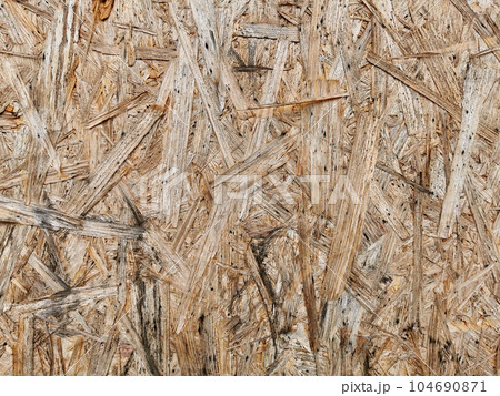 Particleboard wooden wet surface. Background and texture of OSB or MDF board. Particleboard wooden wet surface. Background and texture of OSB or MDF board. 104690871