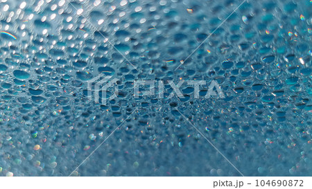 Water drops. Condensed water in the form of hanging drops on the outdoor pool cover. 104690872