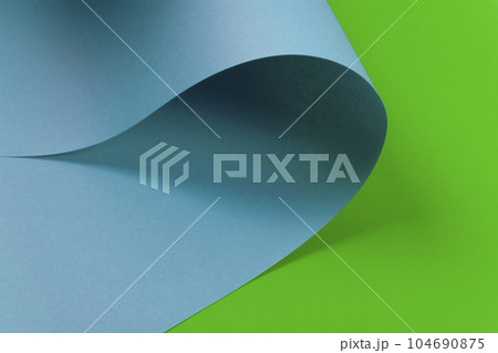Abstract design of blue curve shaped paper on green background. Abstract design of blue curve shaped paper on green background. 104690875