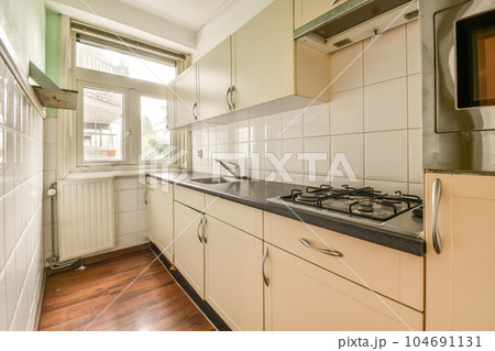 a kitchen with white cabinets and black counter tops in the center of the image is an oven, microwave, toaster and dishwasher 104691131