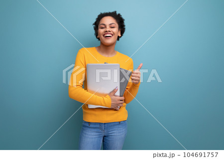 successful young hispanic business woman with black curly hair with laptop and documents successful young hispanic business woman with black curly hair with laptop and documents 104691757