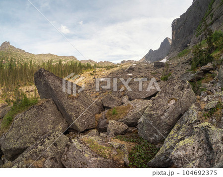 Mountain track through Western Sayans kurumnik, stones, cobblestones, moss with a unique landscape. Landscape photography of stone river (called also stone run, stone stream or stone sea. 104692375