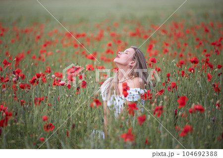 Girl in a flower field Girl in a flower field 104692388