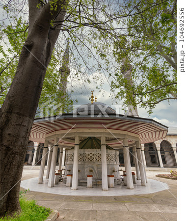 Courtyard of Atik Valide Ottoman Mosque, with ablution fountain in the front, located in Uskudar, Istanbul, Turkey 104692556