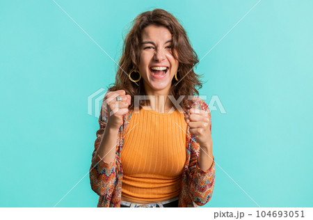 Happy young woman celebrating success, winning, birthday, lottery jackpot goal achievemen, good news 104693051