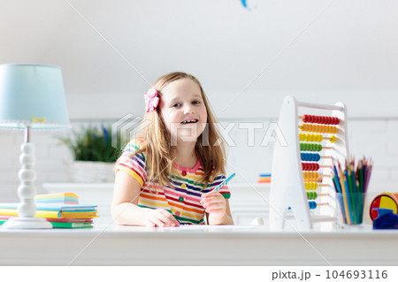 Child with abacus doing homework after school. Child with abacus doing homework after school. 104693116
