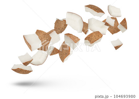 Slices of coconuts on a white isolated background. Coconut slices with a crust fly in different directions, different sides casting a shadow close-up. Coconut isolate. Slices of coconuts on a white isolated background. Coconut slices with a crust fly in different directions, different sides casting a shadow close-up. Coconut isolate. 104693980
