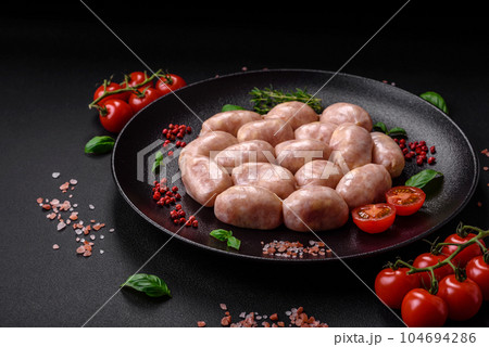Fresh raw sausages from pork or chicken with salt, spices and herbs 104694286
