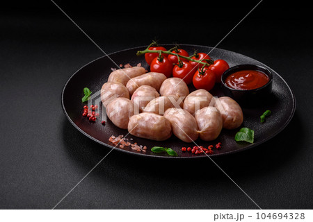 Fresh raw sausages from pork or chicken with salt, spices and herbs 104694328