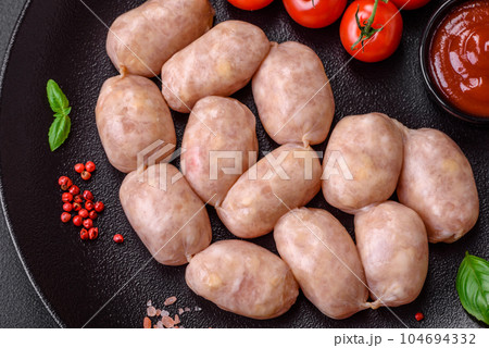 Fresh raw sausages from pork or chicken with salt, spices and herbs Fresh raw sausages from pork or chicken with salt, spices and herbs 104694332