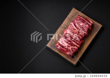Fresh raw beef ribs with salt, spices and herbs Fresh raw beef ribs with salt, spices and herbs 104694438